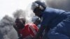 A detained protester cries in front of a burning barricade during a protest against President Pierre Nkurunziza's decision to run for a third term in Bujumbura, Burundi May 13, 2015. A Burundi army general said on Wednesday he had sacked Pierre Nkurunziza