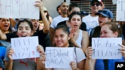 Supporters of the Deferred Action for Childhood Arrivals, or DACA, chant slogans and holds signs while joining a Labor Day rally in downtown Los Angeles on Sept. 4, 2017.