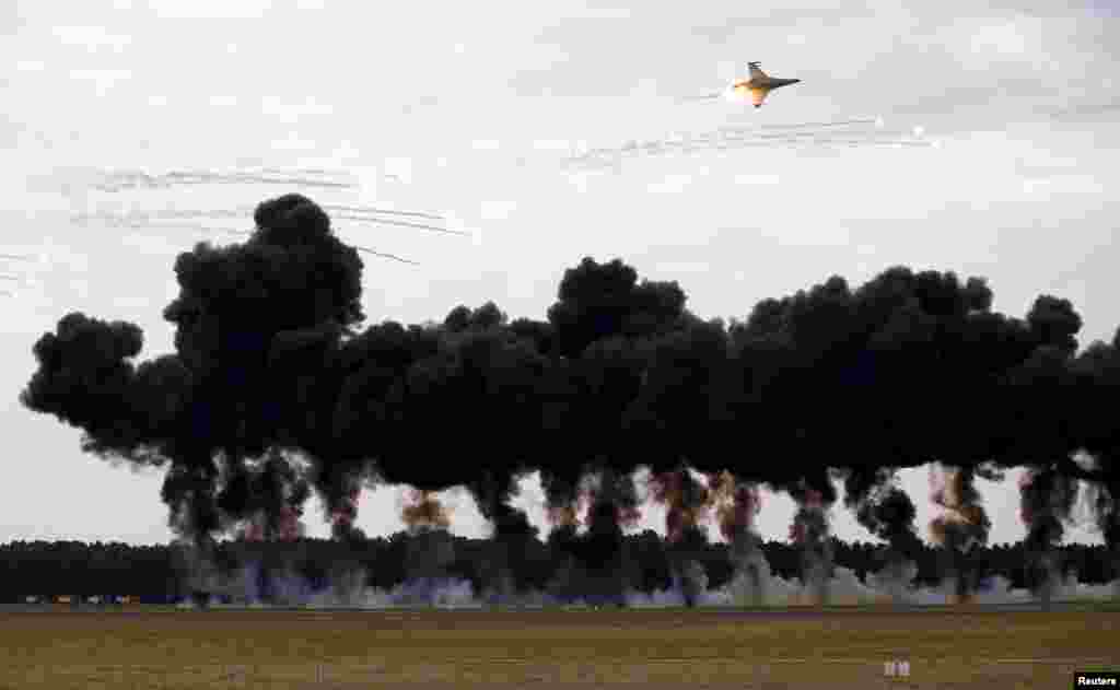 Poland&#39;s military airplanes perform an attack simulation during the Radom Air Show at an airport in Radom, Aug. 23, 2015.