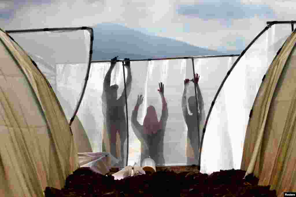 Men work on building a greenhouse in the town of Al Wazzani, near the Lebanese-Israeli border in southern Lebanon.