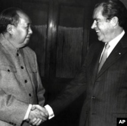 FILE - Chinese leader Mao Zedong shake hands with Richard Nixon after their meeting in Beijing 22 February 1972 during the U.S. President's official visit in China.