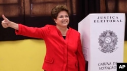Dilma Rousseff, presidential candidate for the Workers Party, next to a ballot box after voting during Brazil's general elections in Porto Alegre, Brazil, Sunday, Oct. 3, 2010.