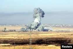 FILE - Smoke rises after airstrikes from the U.S.-led coalition against Islamic State militants in a village east of Mosul, Iraq, May 29, 2016.