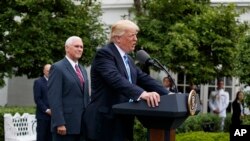 President Donald Trump, accompanied by Vice President Mike Pence, speaks in the Kennedy Garden of the White House in Washington, Monday, May 1, 2017, to the Independent Community Bankers Association. (AP Photo/Evan Vucci)