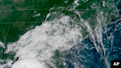 FILE - In this image provided by NOAA, Tropical Storm Gordon approaches the United States on Sept. 4, 2018.