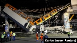 The site where an overpass for a metro partially collapsed with train cars on it is seen at Olivos station in Mexico City, Mexico May 4, 2021. (REUTERS/Carlos Jasso)