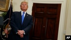 President Donald Trump listens in the Roosevelt Room of the White House in Washington, Aug. 2, 2017, during an event to unveil legislation that would place new limits on legal immigration.