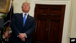 President Donald Trump listens in the Roosevelt Room of the White House in Washington, Aug. 2, 2017, during an event to unveil legislation that would place new limits on legal immigration.