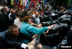 FILE - Riot police separate opposition supporters from members of the pro-Yanukovich Regions Party during a June 2012 rally against a draft language law in Kiev.
