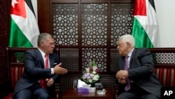 Palestinian President Mahmoud Abbas, right, meets with Jordan's King Abdullah II at his office in the West Bank city of Ramallah, Monday, Aug. 7, 2017.
