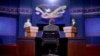 Stand-ins for moderator Jim Lehrer (C), Republican presidential candidate, former Massachusetts Governor Mitt Romney (L) and President Barack Obama (R), run through a rehearsal for the first presidential debate on Wednesday at the University of Denver, in