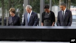President Barack Obama, right, first lady Michelle Obama, second from right, former President George W. Bush, second from left, and former first lady Laura Bush observe a moment of silence at the National September 11 Memorial for a ceremony marking the 1