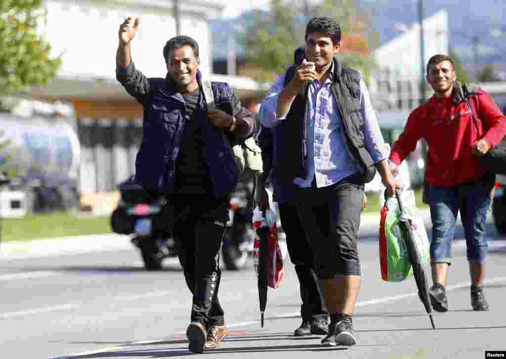 Migrants walk towards Germany at the border crossing with Austria in Freilassing, Germany. Germany cut its train link with the Austrian city of Salzburg, shutting down the main route into its territory for tens of thousands of people caught in Europe&#39;s worst migration crisis in decades.