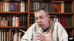 Former presidential candidate Andrei Sannikov speaks during an interview with Reuters at his apartment in Minsk, April 16, 2012. 