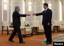 FILE - Iowa Governor Terry Branstad, left, reaches out to shake hands with Chinese President Xi Jinping before a meeting at the Great Hall of the People in Beijing, April 15, 2013.