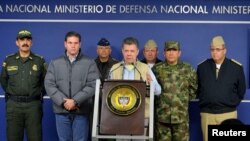 Colombia's President Juan Manuel Santos, center, speaks during a news conference in Bogota, Nov. 16, 2014.