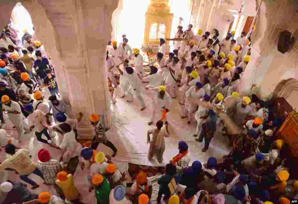 Sikh activists clash with members of the Shiromani Gurudwara Prabhandak Committee during commemorations for the 30th anniversary of Operation Blue Star at the Golden Temple in Amritsar, India. At least two people were wounded after clashes broke out between sword-wielding Sikhs on the anniversary of the notorious army raid on the site.