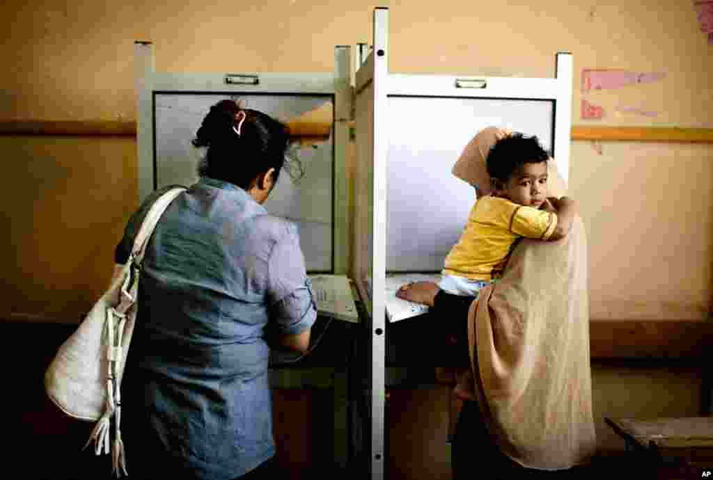 Female Egyptian voters cast their votes during the second day of presidential elections in the Mataraya neighborhood of Cairo, Egypt, Thursday, May 24, 2012. In a wide-open race that will define the nation's future political course, Egyptian voted Thursda