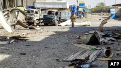 A member of the Yemeni pro-government forces walks through destruction in an industrial district in the eastern outskirts of the port city of Hodeida on Nov. 18, 2018, during the ongoing battle for control of the city from the Huthi rebels.