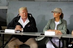 President Donald Trump talks about recovery efforts after arriving with first lady Melania Trump at Luis Muniz Air National Guard Base to survey hurricane damage, Oct. 3, 2017, in San Juan, Puerto Rico.