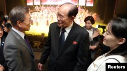 South Korean President Moon Jae-in talks with president of the Presidium of the Supreme People's Assembly of North Korea Kim Young Nam as Kim Yo Jong, the sister of North Korea's leader Kim Jong Un, looks on after North Korea's Samjiyon Orchestra's performance in Seoul, South Korea, Feb. 11, 2018.