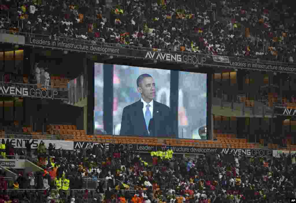 President Barrack Obama speaks to mourners attending the memorial service for former South African president Nelson Mandela at the FNB Stadium in Soweto near Johannesburg, Dec. 10, 2013.