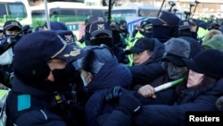 Impeached South Korean President Yoon Suk Yeol's supporters scuffle with police officers as authorities seek to execute an arrest warrant, in Seoul, South Korea, Jan. 15, 2025.