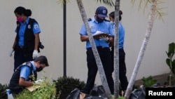 Police check belongings of deceased people outside the morgue in Managua, after an accident that occurred on Wednesday on the Pan-American highway.  Nicaragua, July 28, 2022. REUTERS/Maynor Valenzuela