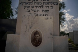 The portrait of a young Cuban soldier who died fighting in The Korean War decorates his tomb at a Jewish cemetery in Guanabacoa, eastern Havana, Cuba, June 7, 2019.