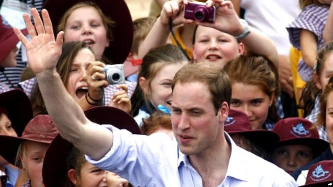 Britain's Prince William waves to residents as he leaves Kerang, March 21, 2011
