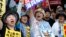 FILE - Anti-U.S. base protesters shouts slogans at a rally in front of the National Diet building on June 19, 2016. 