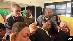 'XYZ Show' creator Godfrey 'Gado' Mwampembwa, right, prepares the puppets for the show at his studio in Nairobi, Kenya, 21 May 2009 (file photo)