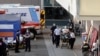 Paramedics escort a patient from the ambulance entrance to the emergency room at LAC + USC Medical Center during a surge of coronavirus disease (COVID-19) cases in Los Angeles, California, Dec. 27, 2020. 