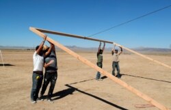 Workers erect a stage at the Little A'Le'Inn on Wednesday, Sept. 18, 2019, in Rachel, Nev. No one knows what to expect, but lots of people are preparing for "Storm Area 51" in the Nevada desert.