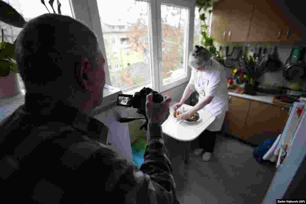 Husband Milan records Jelena Petrovic preparing the food