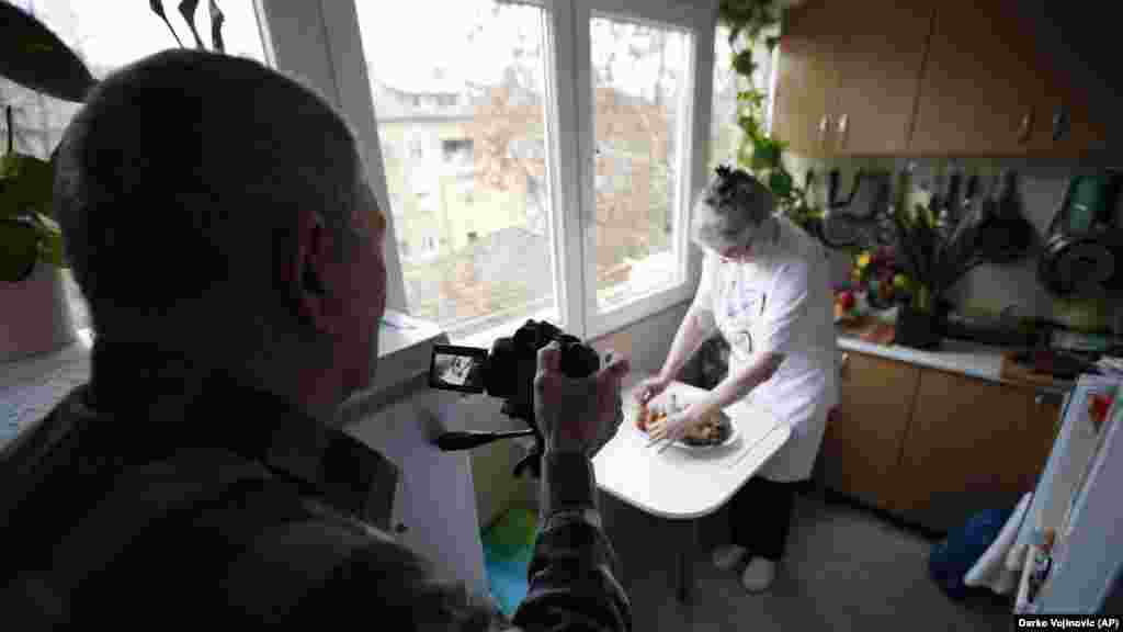 Husband Milan records Jelena Petrovic preparing the food
