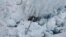 The wreckage of a helicopter carrying tourists is seen crashed in a crevasse on Fox Glacier, a scenic glacier in South Island, New Zealand, Nov. 21, 2015. All seven people, one pilot and six tourists, aboard the helicopter are believed to have been killed.