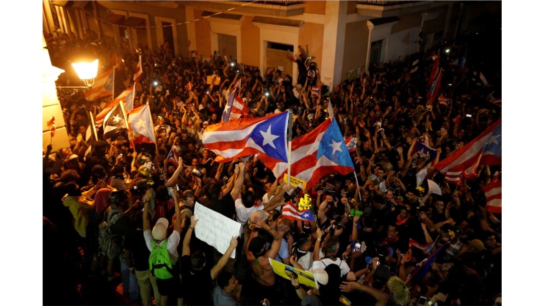 People react after Puerto Rican Governor Ricardo Rossello broadcasted his resignation, in San Juan, Puerto Rico, July 25, 2019.