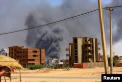 FILE - Smoke rises above buildings after an aerial bombardment during clashes between the paramilitary Rapid Support Forces and the army, in Khartoum North, Sudan, May 1, 2023.