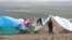 A Syrian refugee looks on in a refugee camp on the Syrian side of the border with Turkey, near Idlib, January 29, 2013.