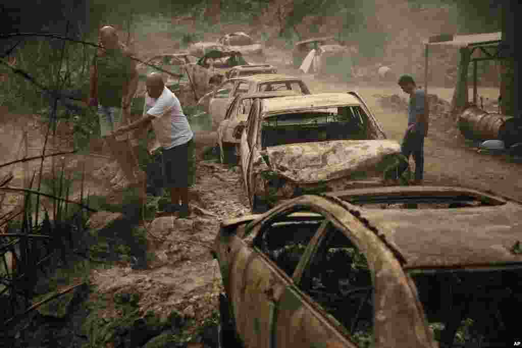 A Lebanese fireman extinguishes a fire near Beirut, Lebanon. Strong fires spread in different parts of the country, forcing some residents to flee their homes in middle of the night as the flames reached residential areas in villages south of Beirut.