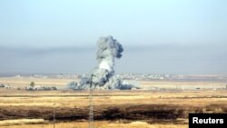 FILE - Smoke rises after airstrikes from the U.S.-led coalition against Islamic State militants in a village east of Mosul, Iraq, May 29, 2016. 