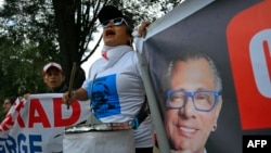 FILE - Supporters of former Ecuadorean Vice President Jorge Glas, pictured on banner, demonstrate outside the National Court of Justice during a court hearing in his case, in Quito, April 12, 2024.