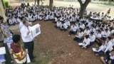 The officers of U.N.-backed genocide tribunal meet high school students at Ek Phnom district in Battambang province, as they distribute recent verdict books of Khmer Rouge leader Kaing Guek Eav, northwest of Phnom Penh, Cambodia, May 5, 2011. 