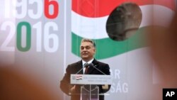 FILE - Hungarian Prime Minister Viktor Orban delivers a speech during the commemoration ceremony of the 1956 Hungarian revolution. Lorinc Meszaros has attributed his success partly to his friendship with Orban.