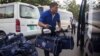 Clothes bags of migrants workers, who are sent back to Cambodia, are seen being transported via van separately after they have exited from the VIP gate at Phnom Penh International Airport on May 11th 2015. (Nov Povleakhena/VOA Khmer)