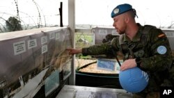 FILE - Capt. Hector Alonso Garcia of the Spanish UNIFIL battalion, the UN force in south Lebanon, shows on a map the blue line, a U.N.-drawn boundary between Lebanon and Israel, at an observation tower in Abbassiyeh, a Lebanese border village with Israel, on January 10, 2024