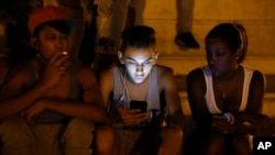 FILE - Cuba's government announced on Tuesday, Dec. 4, 2018 that its citizens will be offered full internet access on mobile phones starting Thursday, Dec. 6, becoming one of the last nations to do so. (AP Photo/Desmond Boylan, File)
