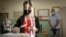 A woman casts her vote in Sofia, Sunday, July 11, 2021. Bulgarians are voting in a snap poll on Sunday after a previous election in April produced a fragmented parliament that failed to form a viable coalition government.