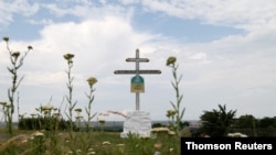 A view shows a cross near the crash site of Malaysia Airlines Flight MH17 plane outside Hrabove.